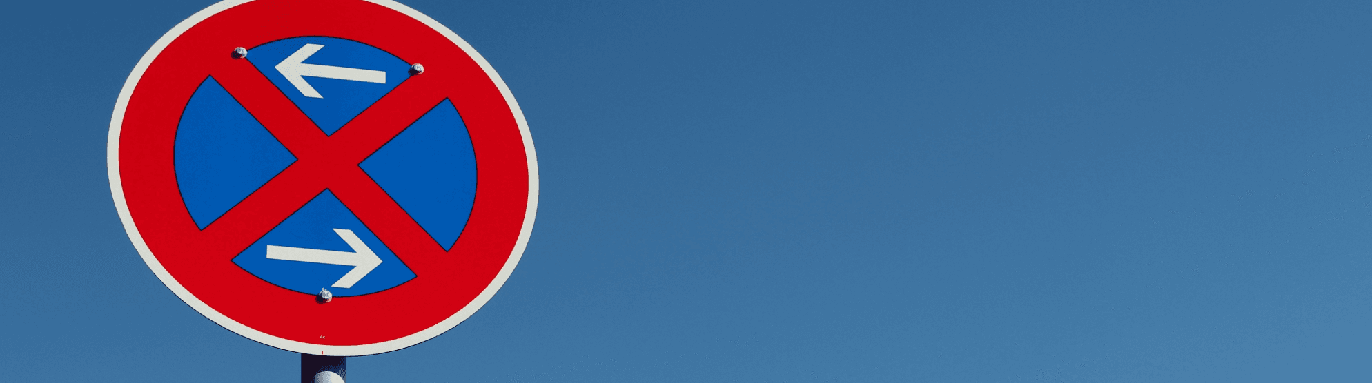 No stopping sign (arrows left/right). Information to apply for a no-parking zone.
