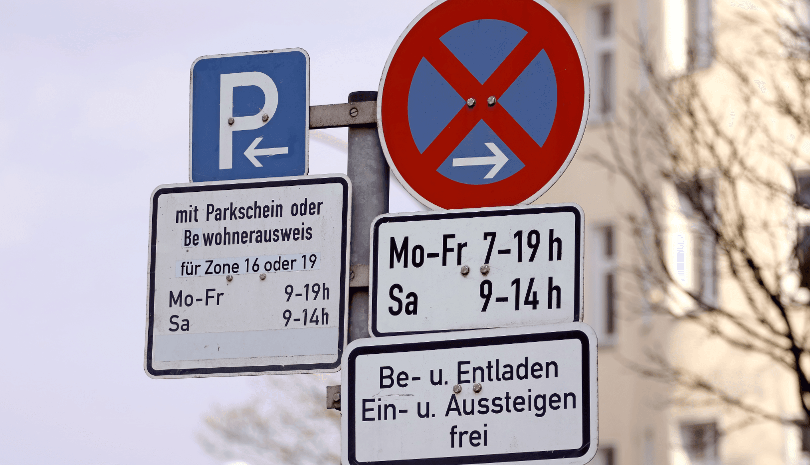 No-stopping zone signs for a move with time restrictions; loading/unloading and pick-up/drop-off allowed.