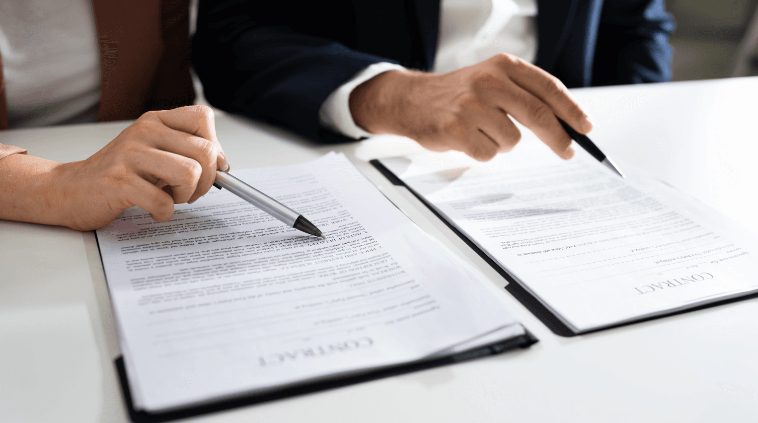 Two people reviewing contracts – transparent pricing and secure planning for piano transport & grand piano relocatio