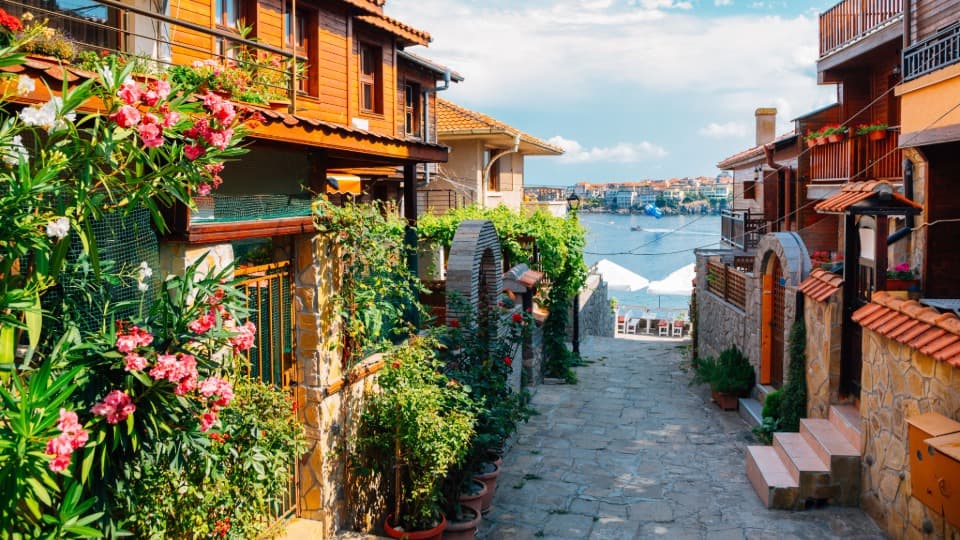 Gasse in der Altstadt von Sozopol mit Blick auf das Schwarze Meer – Wichtige Sicherheitshinweise zu Strömungen und Alltagsvorsorge in Küstenorten.