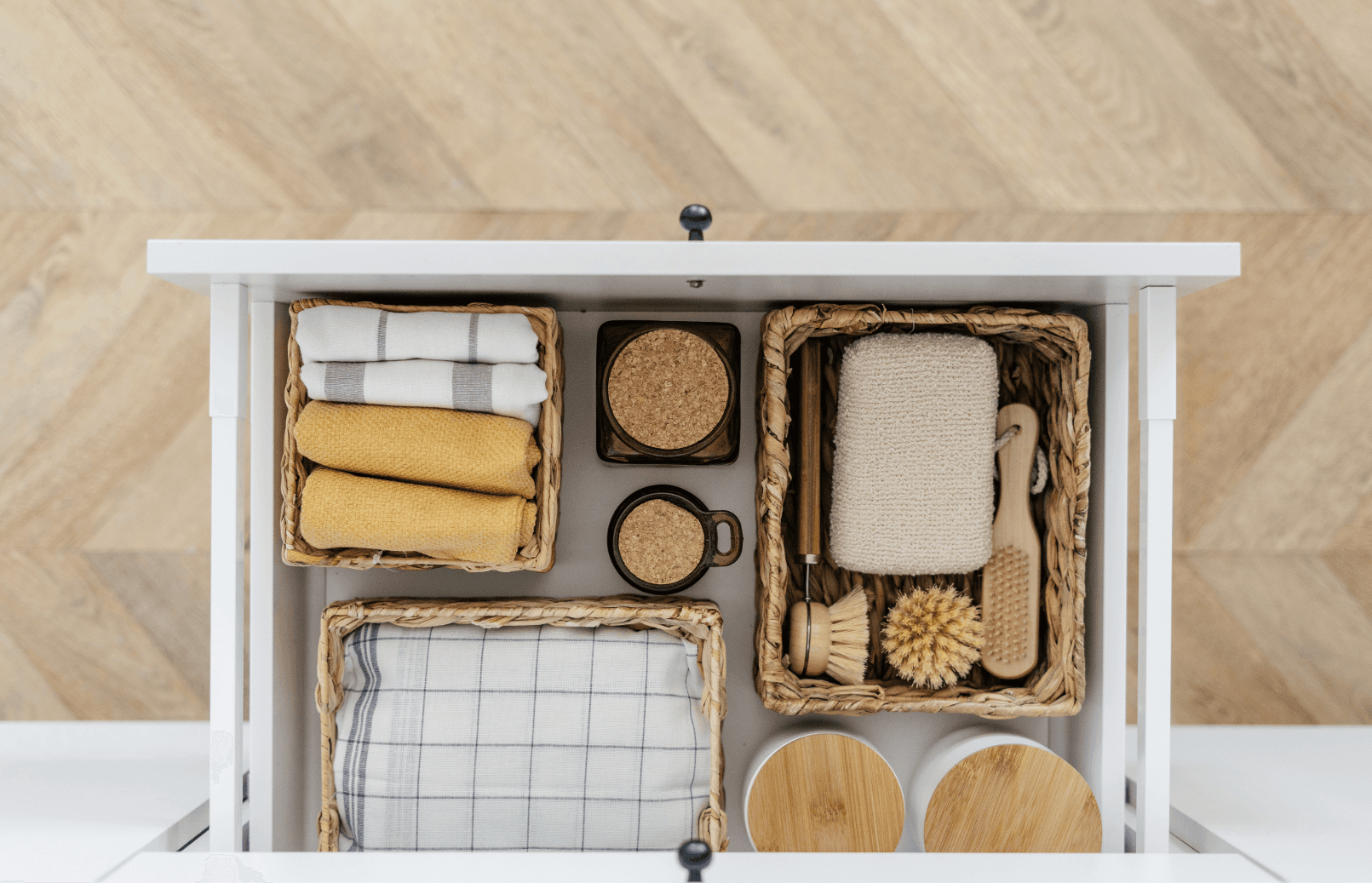 Organized drawer with baskets and household items – space-saving tips for moving into a smaller apartment