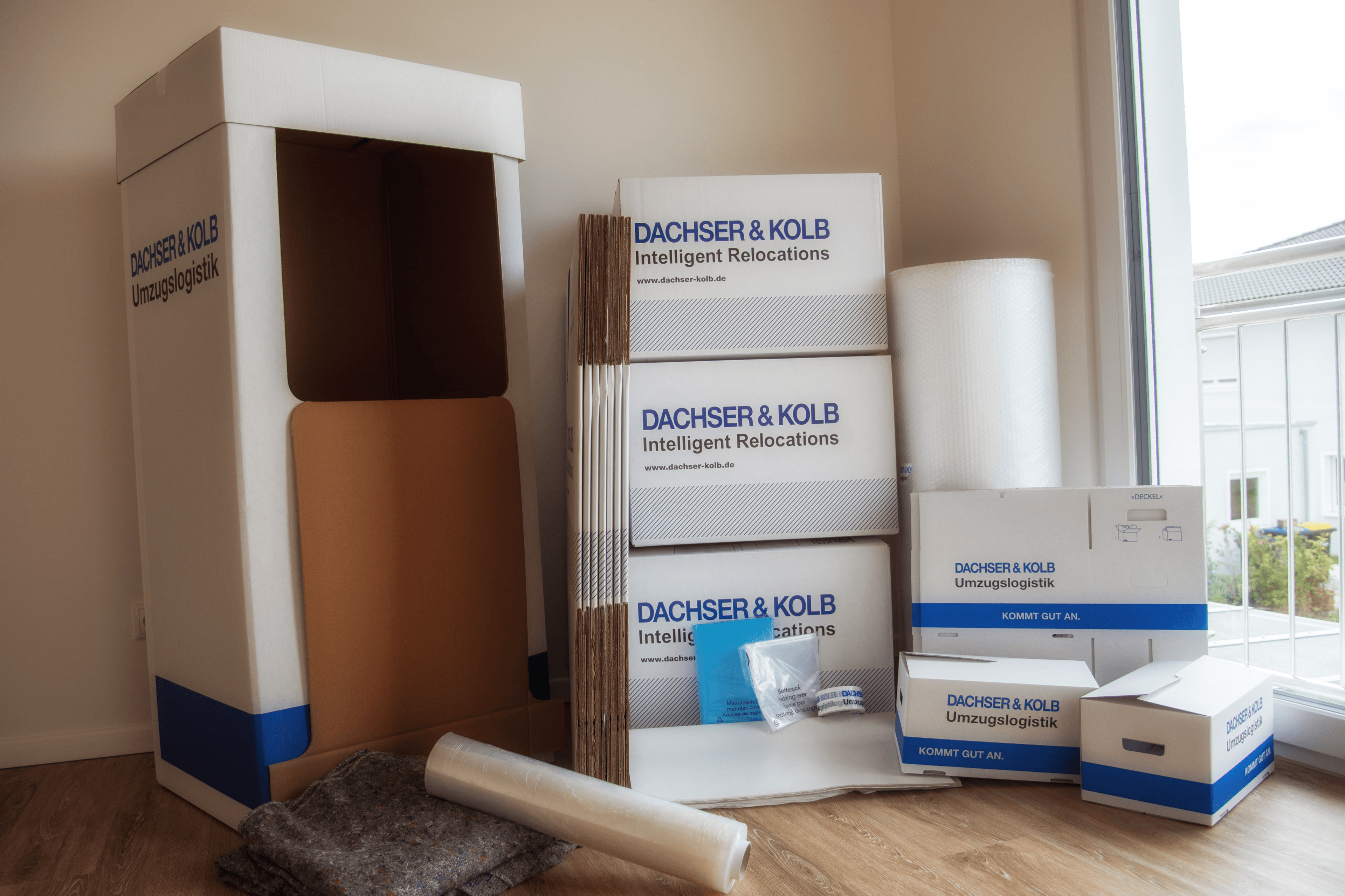 Boxes, bubble wrap and accessories arranged in a bright corner of an apartment