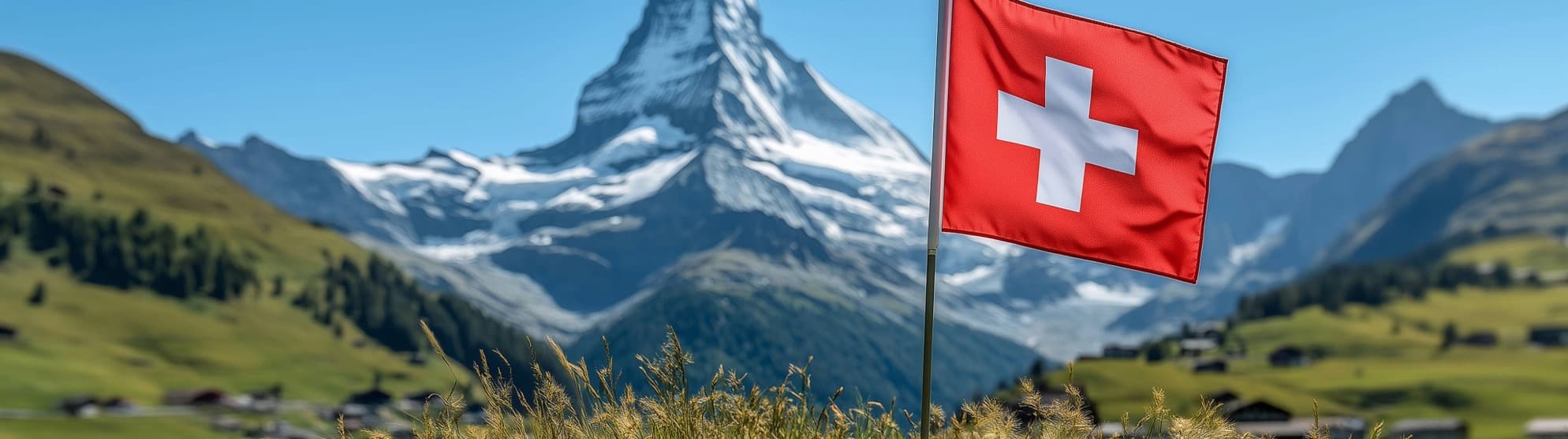 Swiss flag in front of an Alpine landscape with the Matterhorn under a clear sky