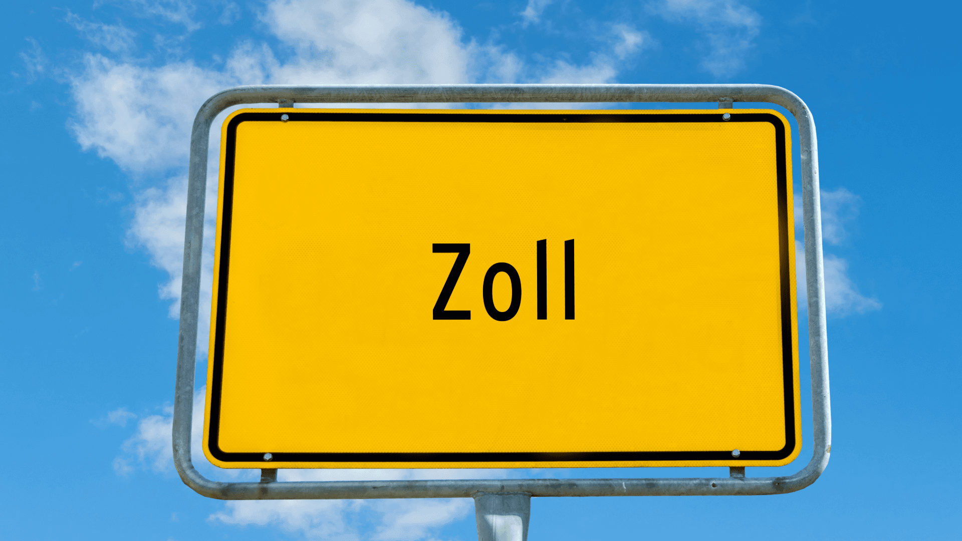 Gelbes Verkehrsschild mit Aufschrift „Zoll“ vor blauem Himmel