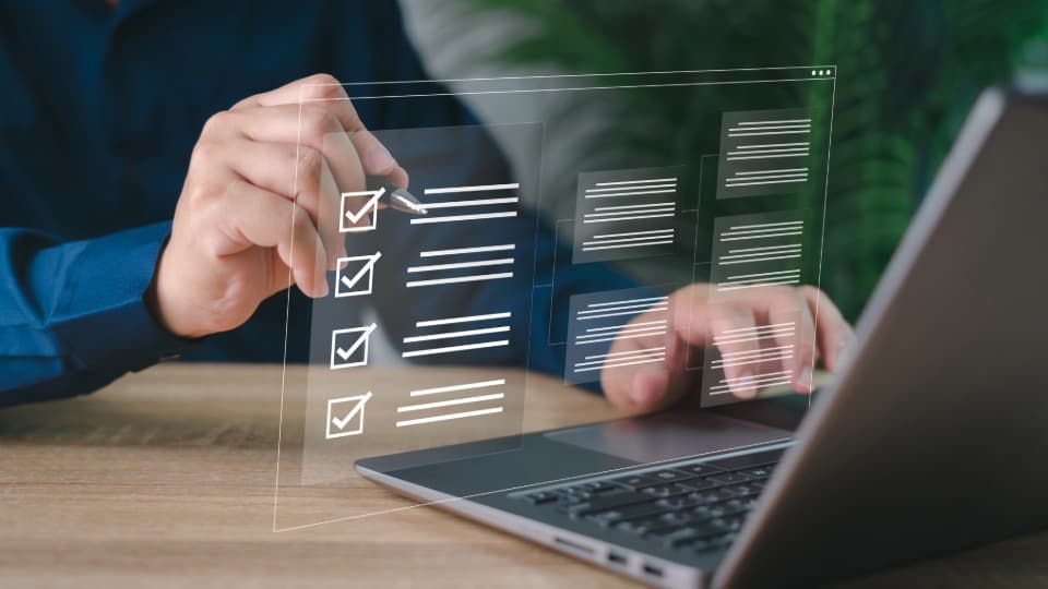 Person nutzt Laptop und hakt digitale Checkliste für Außenaufzug-Einsatz ab.