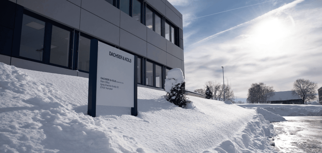 Company building with snowy exterior during winter move – clear sky and sunlight in the background