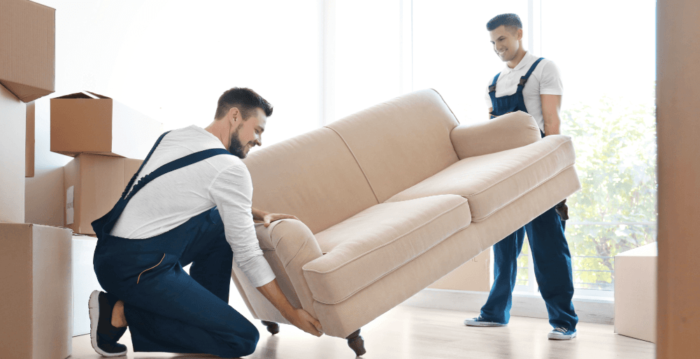Two movers lifting a sofa – easy and reliable small furniture transport service.