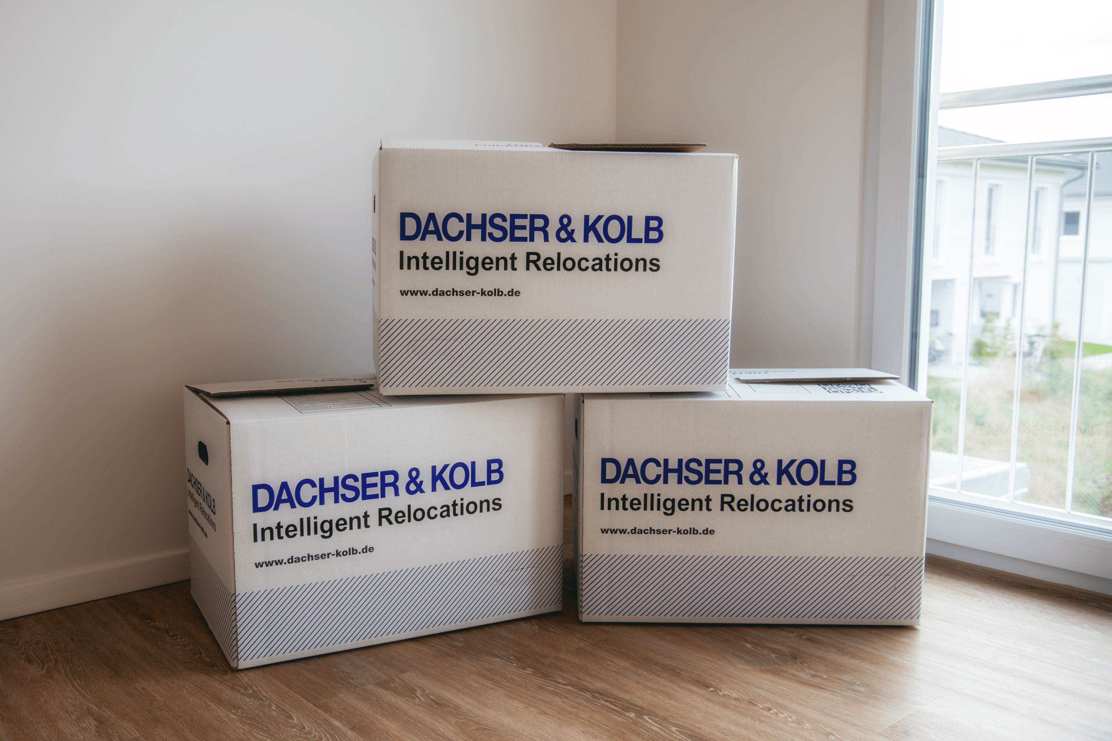 Stacked moving boxes in empty room – proper disposal and recycling of packing materials during a move