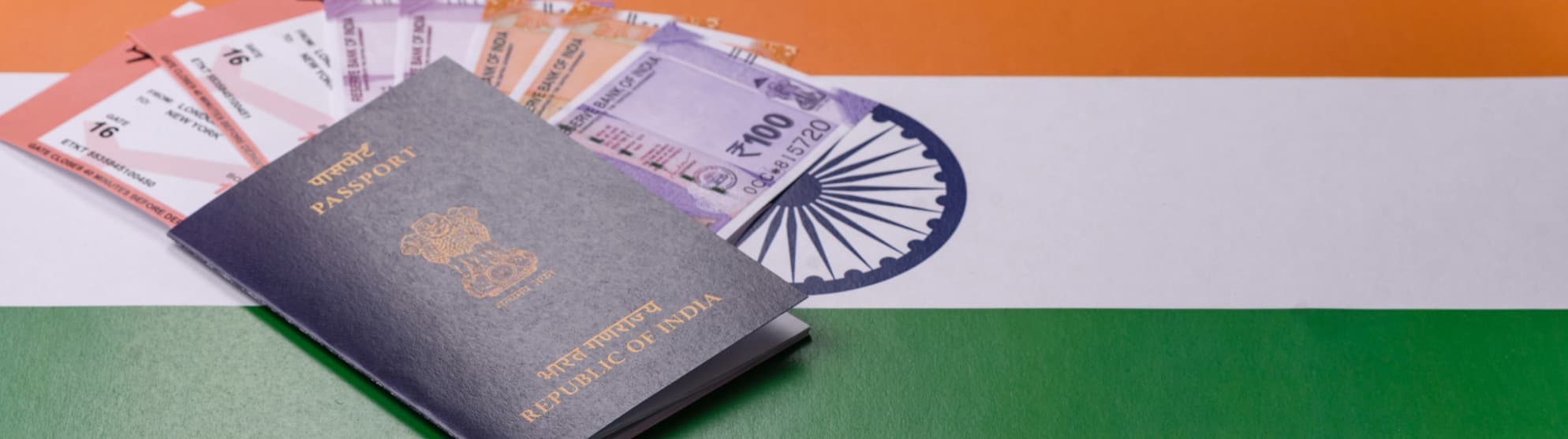Indian passport with visa documents and rupees on the flag of India